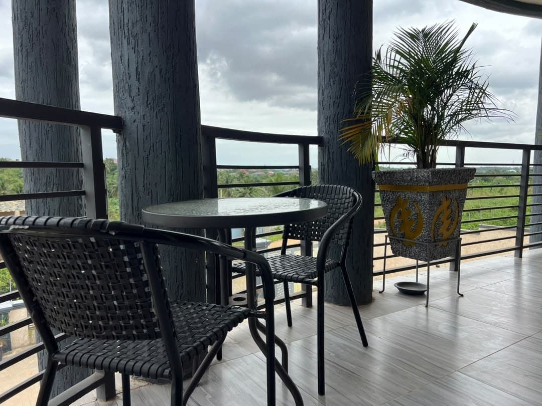 Unit 4 front porch, with chairs and a view over the trees