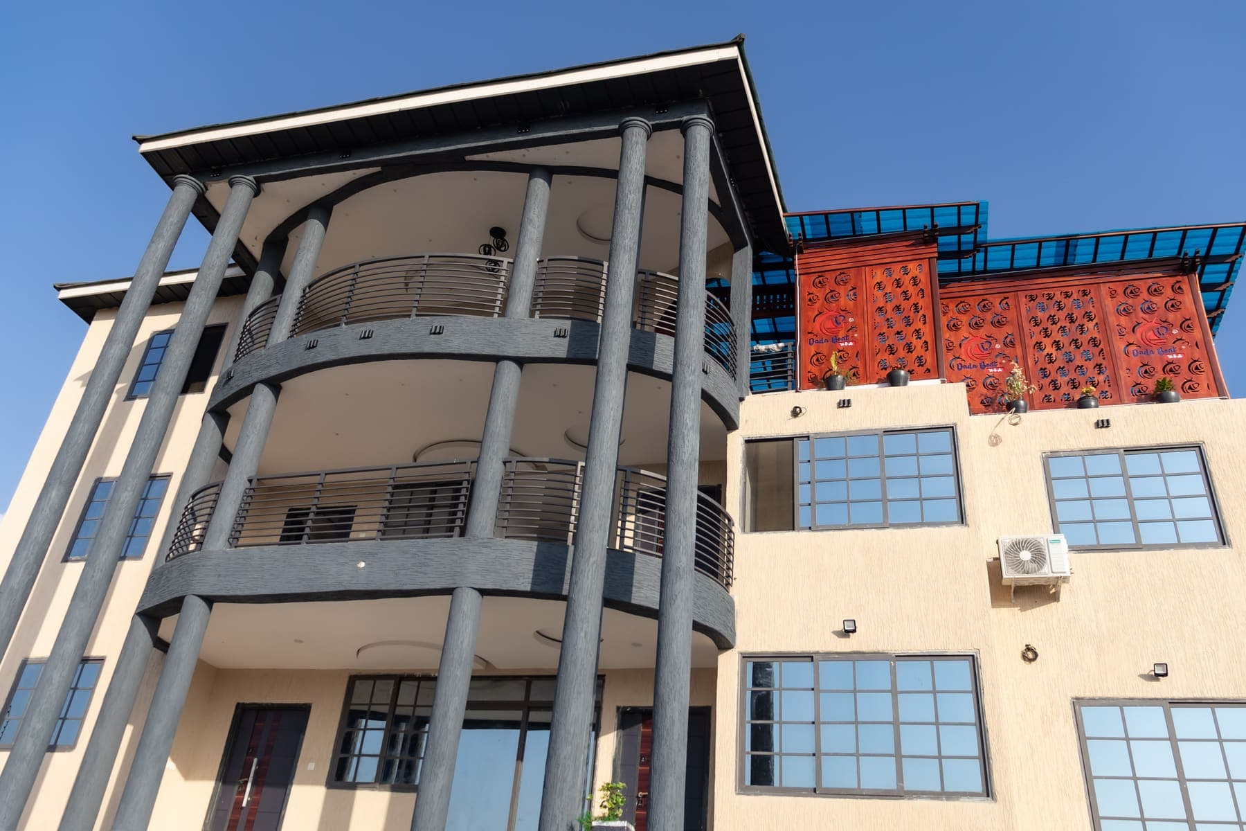 The DeHideout building in Diabene, Takoradi, with curved balconies and a terracotta lattice